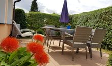 Terrasse mit umfangreicher Möblierung, Grill und schöner Blumen-Bepflanzung