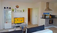 Der moderne offene Wohnbereich mit Essecke und Küche im Appartement Fienchen