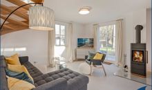 Wohn-/Esszimmer mit Kamin und offener Küche