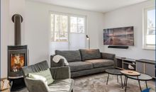 großzügiges Wohn-/Esszimmer mit Kamin, offener Küche und Zugang zum Garten