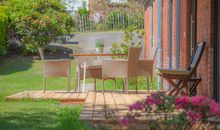 sonnige Terrasse mit gemütlichen Sitzgelegenheiten